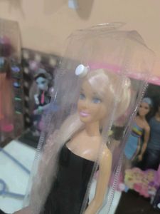 Hannah doll in black dress with long hair.