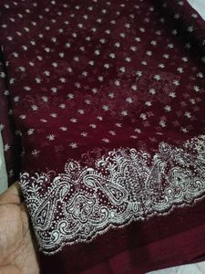 Burgundy saree having white design print.
