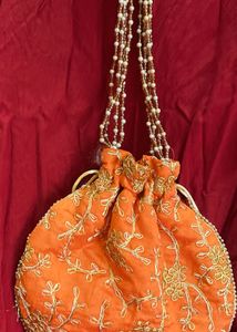 Handcrafted Orange Potli Bag with Intricate Gold