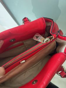 guess hand bag in red colour