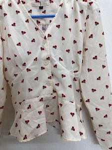 long-sleeved peplum blouse in an off-white