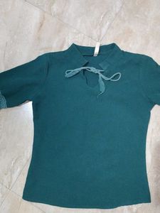A dark green , full sleeve top