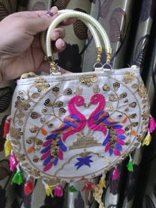 Cream Coloured Sling Bag With Multicolored Design.