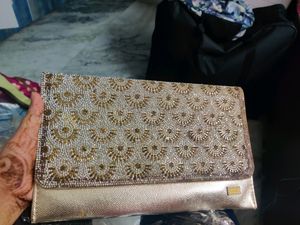 golden clutch bag with sling string