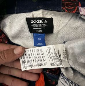 This is an Adidas x Rita Ora navy floral pullover