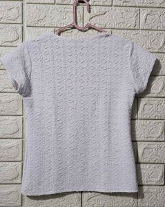White, short-sleeve top with a textured pattern