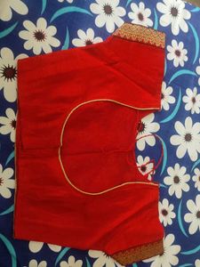 A Light Organe Saree With Red Broad Embroidery