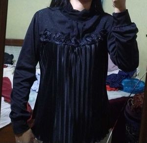 Elegant black pleated top.