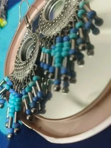Silver Jhumkas With Blue Beeds.