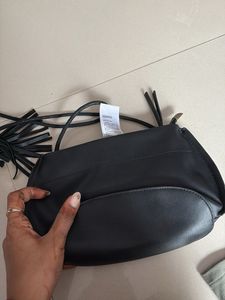 Chic Black Sling Bag with Tassel Detail