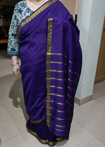 Purple coloured artificial silk saree with 1.5 inch ethnic design golden border