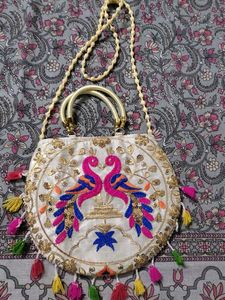 Cream Coloured Sling Bag With Multicolored Design.