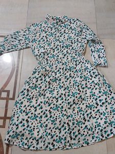 a middi of white colour having green nd black dots