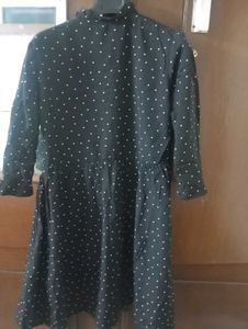 Black midi length dress with white dots.