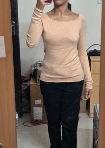 light beige or nude-colored long-sleeve top