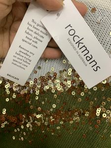 khaki green and white sweater with gold sequins
