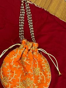 Handcrafted Orange Potli Bag with Intricate Gold