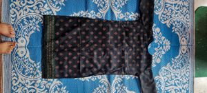 pure cotton black colour long kurta which has red and green printed flowers ..the kurta is unused