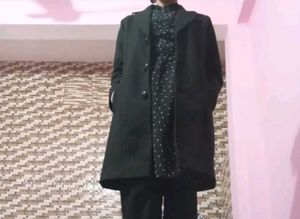 Black midi length dress with white dots.