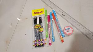 combo of pens scale and eraser