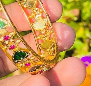 Elegant Gold Bangle with Green and Pink Stones