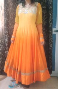 A very pretty orange and yellow double shaded full flayar anarkali with chudidar and pretty orange dupatta