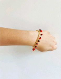 GOLD CHAIN BRACELET WITH RED &amp; BLACK CHARMS