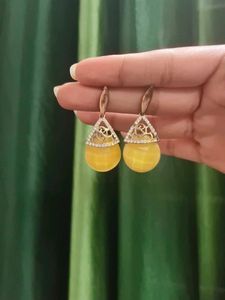 White Earrings Amd Golden Jhumkas.