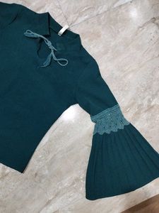 A dark green , full sleeve top