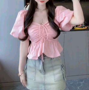 pink puff-sleeve peplum top with a ruched front an
