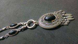 A Black Necklace along With White One