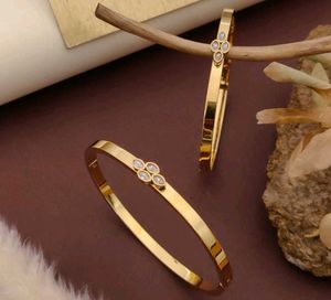 Gold Tone Flower Bangle Set