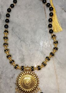 Black and golden preals necklace
