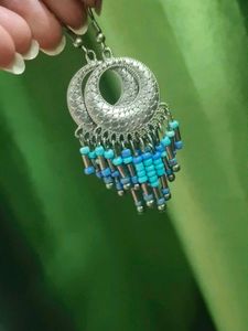Silver Jhumkas With Blue Beeds.