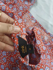 Red top with floral blue pattern