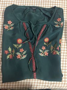 Bottle, green colour, full sleeves, top with elastic at the sleep, end and embroidery work in the front and in the arms of the top