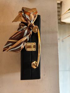 Structured Black Sling Bag with Golden Straps