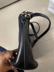 Black Sling Bag From Ajio. This Sling Is Sturdy and Useful For Keeping A Small Purse Along With Two Phones And Other Small Items. Bag Has 5 Compartments.