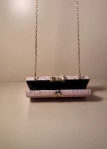 rose‑gold glitter box clutch with bow clasp, chain