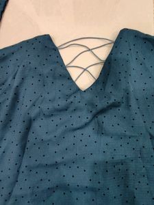 Blue Top With Black Buttons And Design On Back.
