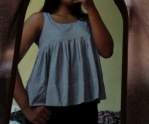 Sleeveless, loose-fit peplum top.