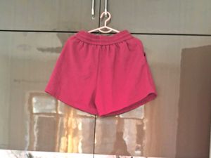 A pair of fuchsia shorts with  drawstring waist
