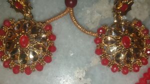 Red  chokar set with earing Base Metal:   Choker and EarringsRed  chokar set with earing  this jwellery set looks beautiful with traditional dress like lehenga saree and suits etc.