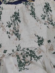 a white body fitted top in flower pattern