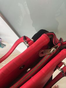 guess hand bag in red colour