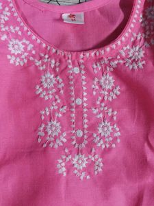 Traditional pink kurti with white embroidery.