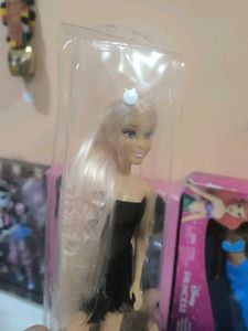 Hannah doll in black dress with long hair.