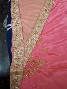 It Is Pink Color Georget With Golden Net Border .