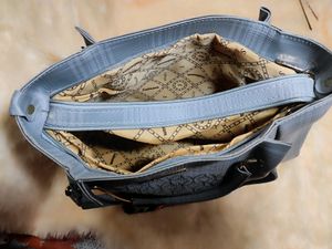 A Sophisticated Grey Handbag With Two Handles