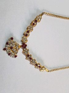 Elegant Gold Necklace With Maroon Stone